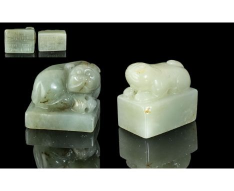 A Pair of Two Jade Seals both surmounted by stylised beasts with Archaic script to base. 