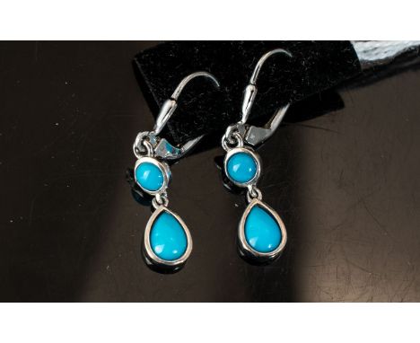 Turquoise Double Drop Earrings, each earring comprising a pear cut cabochon turquoise below a round cut and suspended from pl