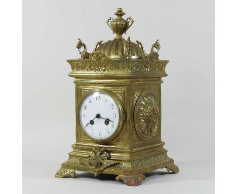 An ornate brass cased mantel clock, having a white enamel dial and eight day movement, striking on a gong36cm high