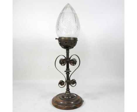 An unusual early 20th century newel post lamp, the scrolled base with flowerhead decoration, supporting a hobnail cut domed s