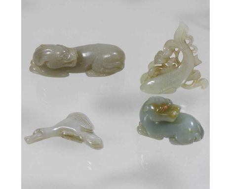 An oriental jade coloured hardstone carving of a recumbent dog, together with three other carvings of animals (4)