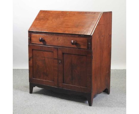 A 19th century mahogany bureau, with cupboards below, on bracket feet92w x 54d x 107h cm
