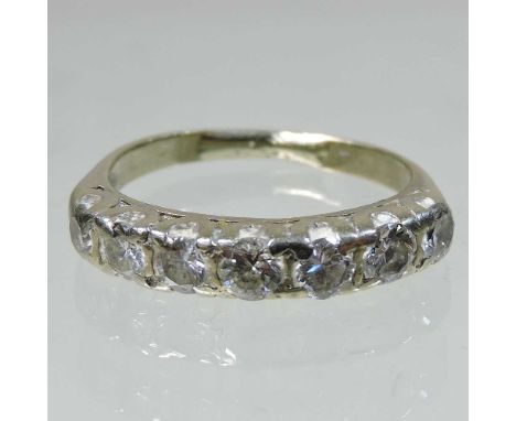 An unmarked diamond half hoop eternity ring, set with a row of seven stones, 3.9g gross, size M