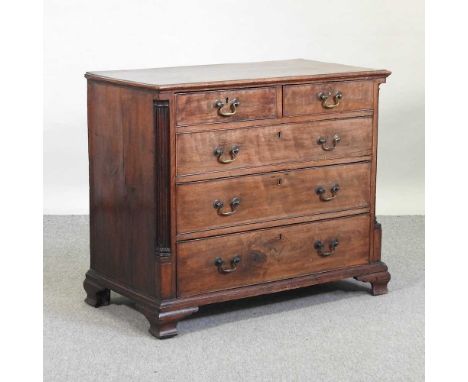 A George III mahogany chest, containing two short over three graduated long drawers, flanked by reeded pilasters, on bracket 