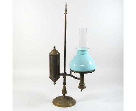 An early 20th century brass student's lamp, with an adjustable base and opaque green glass shade57cm highCondition report: Ov