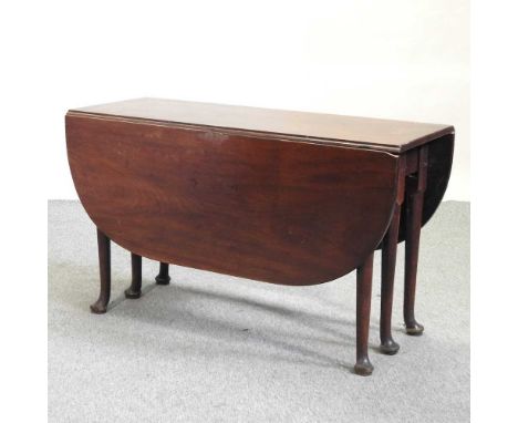 An 18th century mahogany pembroke table, with a hinged oval top, on double gate six legged supports, terminating in pad feet1
