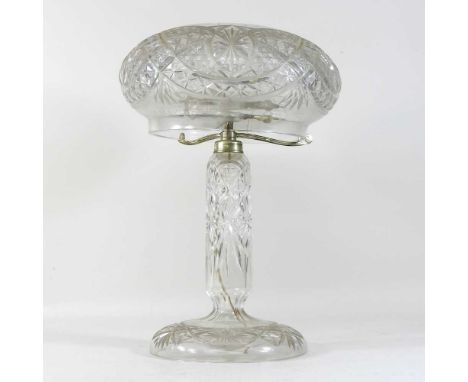 An early 20th century cut glass table lamp, with a mushroom shaped shade, with plated mounts, on a domed base47cm high