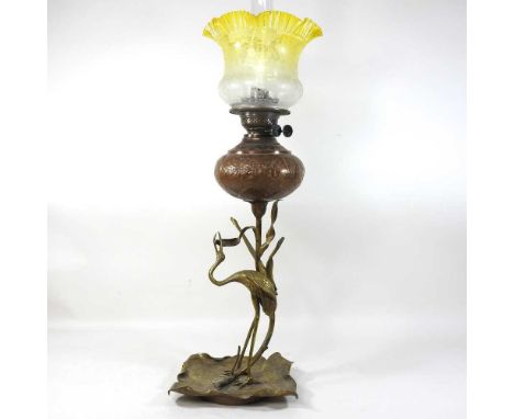 An unusual late 19th century Arts and Crafts copper and brass oil lamp, in the form of a crane amongst reeds, with a copper r