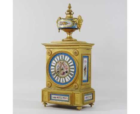 An ornate French style mantel clock, with gilt metal mounts and Sevres style porcelain panels, painted with cherubs, the eigh