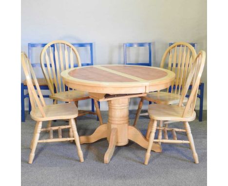 A tile top beech extending dining table, with a set of four dining chairs and a set of four blue painted rush seated dining c
