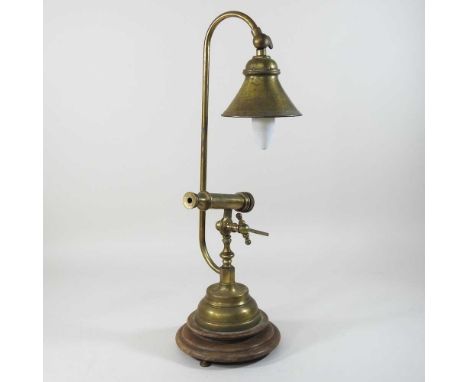 A 20th century brass reading lamp, with lens, on a wooden base55cm high