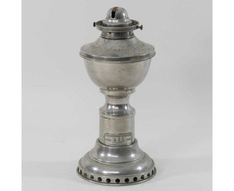A mid 20th century metal patent clockwork oil lamp base, stamped The Kranzow Lamp, Sherwoods Ltd, with a winding mechanism be