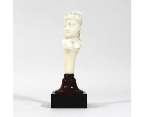 A 19th century carved ivory parasol handle, in the form of the head and shoulders of a young lady, mounted on a plinth base. 