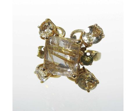 An unmarked rutilated quartz seven stone cluster ring, with a central square stone, within an openwork surround, size N, appr