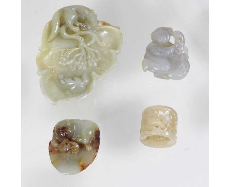 An oriental jade coloured hardstone carving of a leaf, together with three other smaller carvings (4)