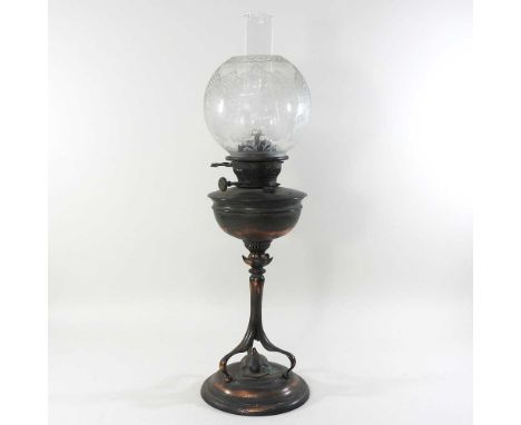 An Arts and Crafts copper oil lamp and shade, circa 1900, in the manner of W A S Benson, with a stylised column, with an etch