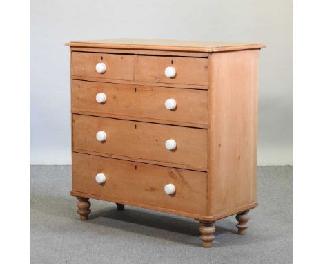 A Victorian pine chest, containing two short over three long drawers, with white ceramic handles, on turned feet99w x 45d x 9