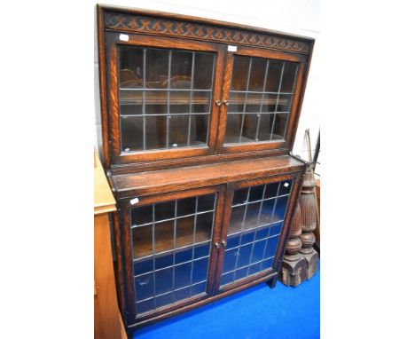 An Edwardian oak book case having leaded light doors in good condition.