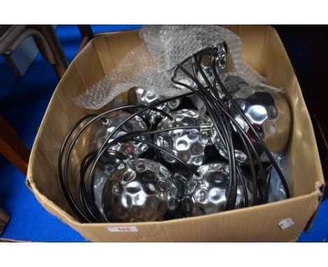 A modern drop ceiling light fixture with chrome shades.