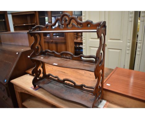 A Victorian Watnot Shelf with carved frame work.