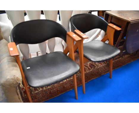 A pair of mid century Kai Kristiansen Compass style arm chairs.