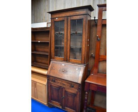 An early 20th century bureau book case with leaded light windows.