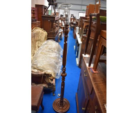 An Edwardian standard lamp having turned oak frame.