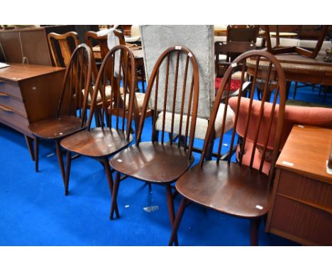 A set of four Dark stained Ercol hoop back dining chairs.