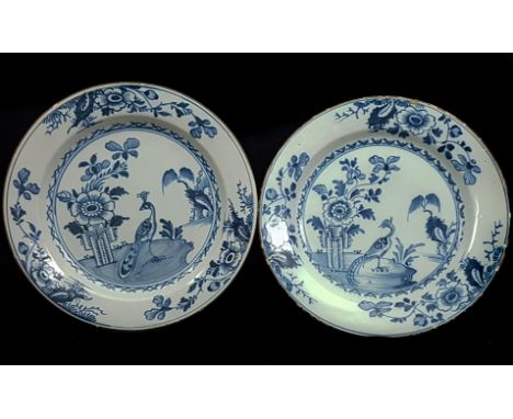 Two English Delftware plates, painted in blue with pheasant and peony patter, chocolate brown line rims, 23cm diam approx (2)
