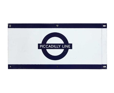 'PICCADILLY LINE', a London Underground enamel frieze sign, painted on reverse 'F1 GP',24.5 x 53.5cmCondition report: chips t