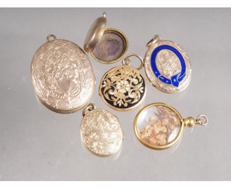 A yellow metal and black enamel mourning locket, a smaller similar and four other yellow metal lockets