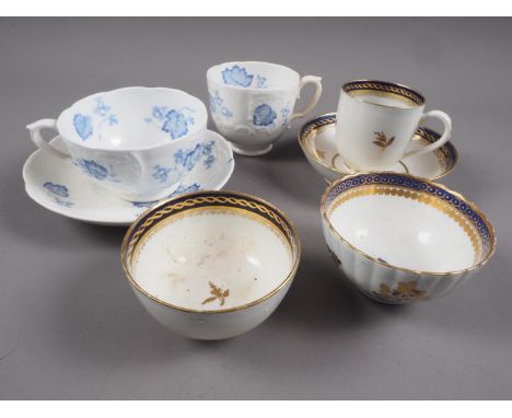 A Caughley tea bowl, saucer and coffee cup, a similar tea bowl, a Grainger Lee &amp; Co Worcester blue and white trio, a&nbsp