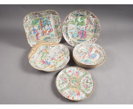 A Chinese Canton enamel part dessert service of three dishes and five plates with figure decorated centres, floral and bird d