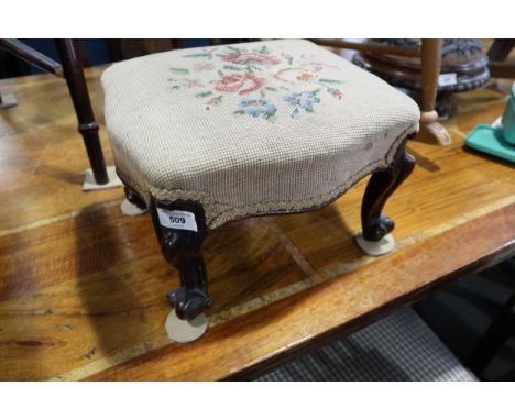 A 19th century rosewood footstool, upholstered in a tapestry floral design, on scroll supports, 13" wide, a circular beadwork
