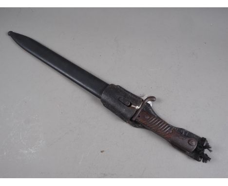 A German WWI butcher's sawback bayonet, in metal scabbard with frog and leather holder , 20 1/2" overall 