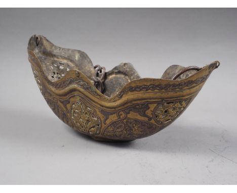 An Islamic Persian embossed brass and pierced hanging incense burner, on copper chain, 9" wide 
