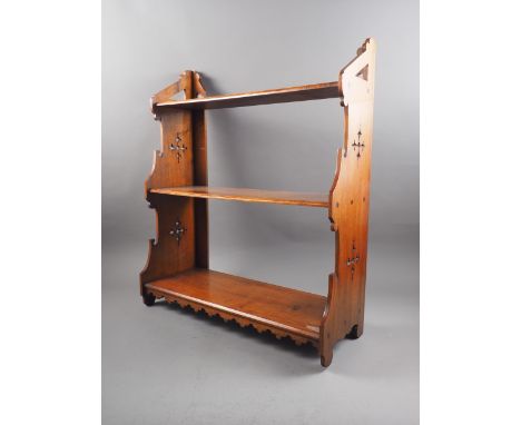 A 19th century walnut three-tier open wall shelf with Gothic pierced sides, 23" wide x 8 1/2" deep x 27" high, and an Edwardi