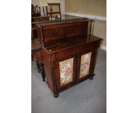 A Regency mahogany and brass gallery top chiffonier, fitted shelf over one long drawer and cupboards enclosed two embroidered