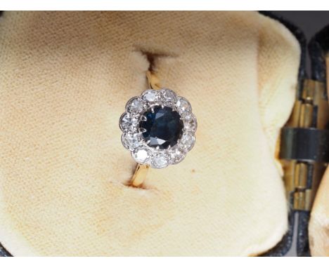 An 18ct gold, platinum, sapphire and diamond cluster ring, size O, 3.7gCondition:The ring is slightly worn, there's a split t