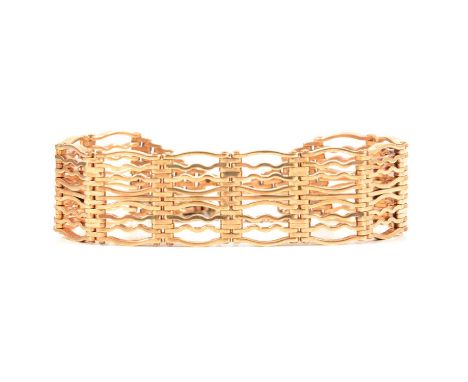 A 9 carat yellow gold 20mm wide gate link bracelet, Birmingham 1990, fitted with a padlock fastener, 50g.