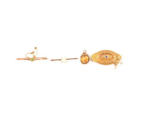 Three Victorian and later brooches, a yellow metal oval Etruscan style target brooch with blue stone and seed pearls to centr