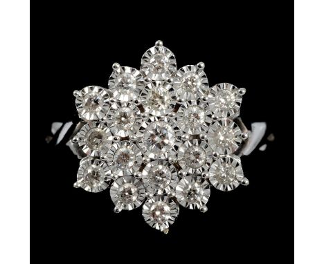 An illusion set diamond cluster ring, nineteen brilliant cut diamonds illusion set in a 9 carat white gold three tier snowfla