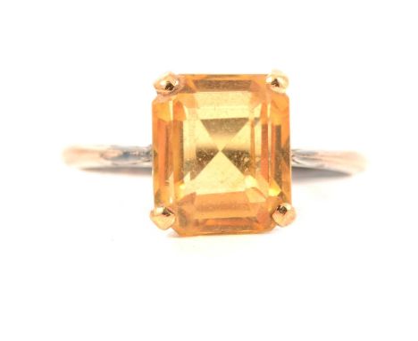 A citrine dress ring, the emerald cut stone 10 x 8.5mm four claw set in an all yellow metal mount ring size M, gross weight 2