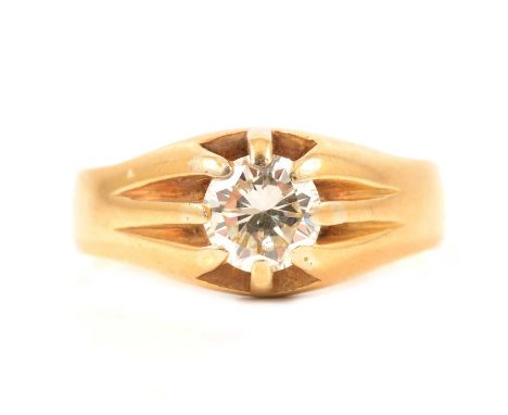 A diamond solitaire ring set in a gentleman's style mount, the brilliant cut stone set with eight claws in an all yellow meta