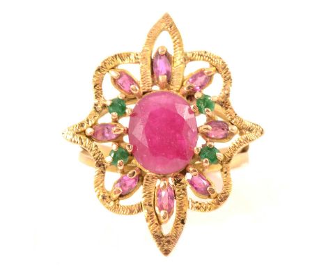 A fancy ruby and emerald ring, the oval mixed cut central ruby approx. 8.8mm x 8mm with two small round brilliant cut emerald