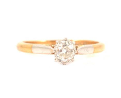 A diamond solitaire ring, the slightly oval old brilliant cut stone claw set in a yellow and white metal mount ring size K, s