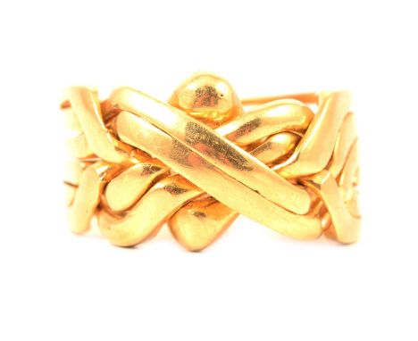 A yellow metal puzzle ring, the six bands on the shank forming a 12mm wide knot to the front, ring size R centre, stamped 750