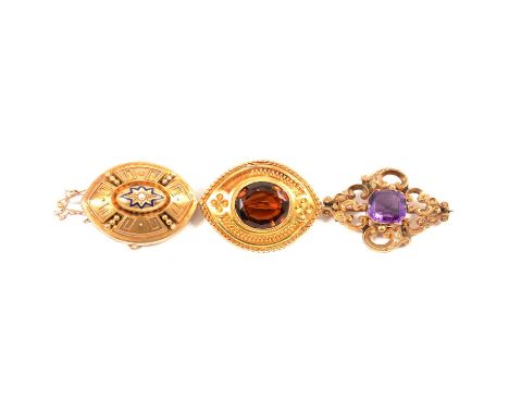 Three Victorian brooches, a rectangular canted corner amethyst set in a in a hollow scroll design frame, 40 x 30mm; a yellow 