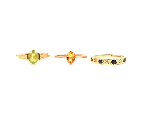 Three gemset rings, an oval mixed cut peridot 8 x 6mm, claw set in an all yellow mount ring size P, shank marked 9ct; an oval