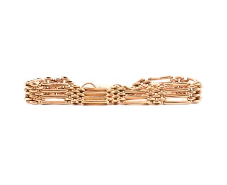 A 9 carat yellow metal four bar 10mm wide gate link bracelet, polished and etched links, fitted with a scroll engraved padloc